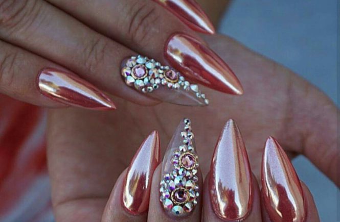 Rose gold chrome acrylic stiletto nails with rhinestone accent
