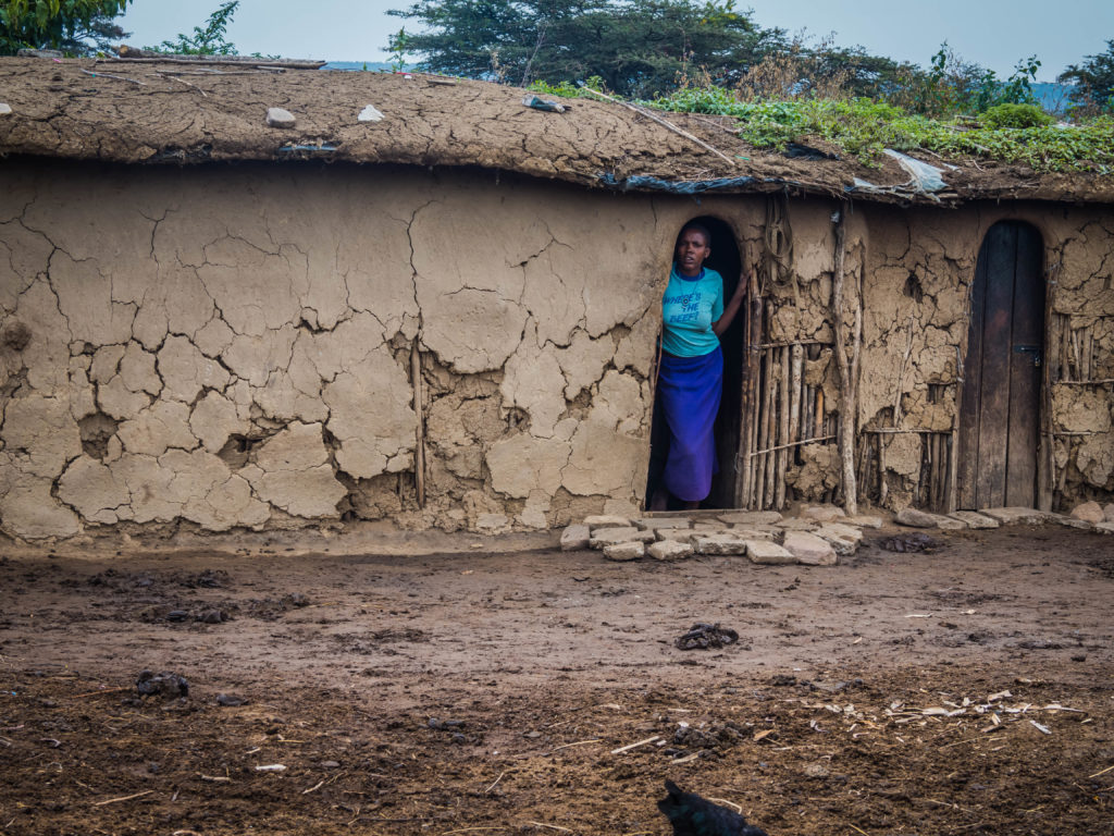 Travel - Visiting a Maasai Village - Kenyan woman outside her hut