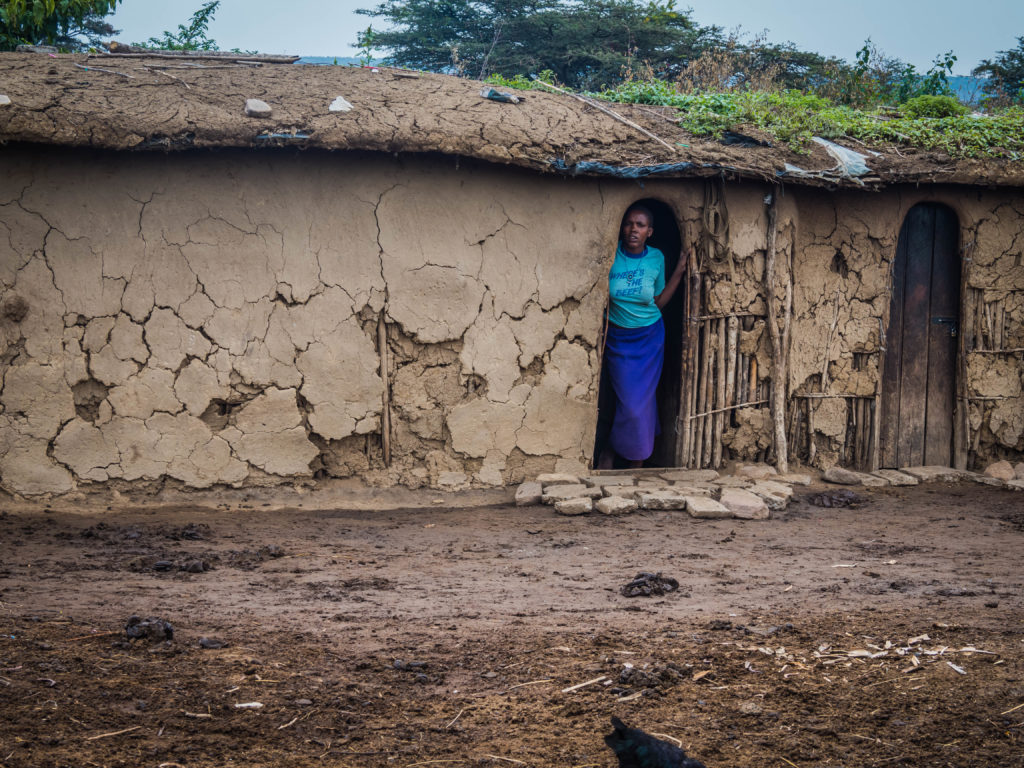 Travel - Visiting a Maasai Village - Kenyan woman outside her hut