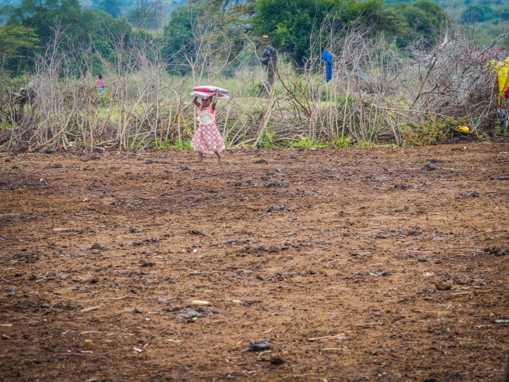 Travel - Visiting a Maasai Village - Kenyan Maasai girl in a traditional village