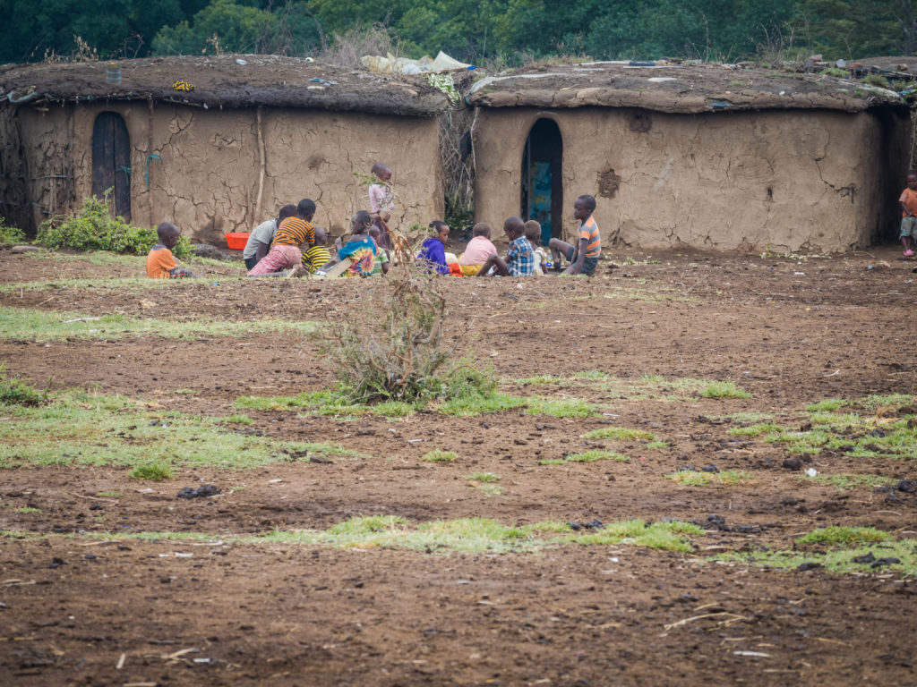 Travel - Visiting a Massai Village - Maasai children gathering in a traditional village
